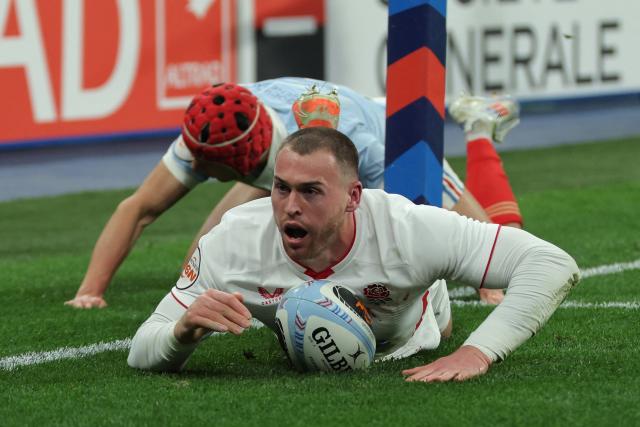 England's wing Tom Roebuck dives over the line to score England's first try during the Six Nations international rugby union match between France and England at the Stade de France, in Saint-Denis, north of Paris, on March 14, 2026. (Photo by Thomas SAMSON / AFP)