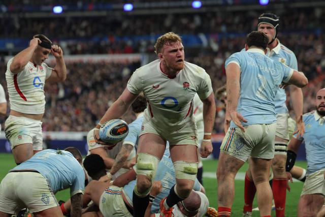 England's lock Ollie (C) celebrates after scoring England's third try during the Six Nations international rugby union match between France and England at the Stade de France, in Saint-Denis, north of Paris, on March 14, 2026. (Photo by Thomas SAMSON / AFP)