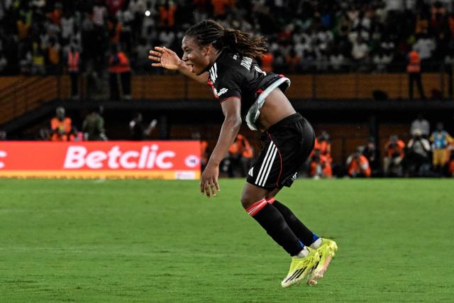 OL-Lyonnes's Haitian midfielder #06 Melchie Dumornay celebrates after scoring a goal during the France LFFP Cup football final match between Paris Saint-Germain (PSG) and OL Lyonnes (Lyon) at the Felix Houphouet-Boigny stadium in Abidjan on March 14, 2026. OL Lyonnes won the inaugural Women’s League Cup, comfortably beating Paris SG 1-0 thanks to a goal from their Haitian striker in Abidjan, Ivory Coast, where the final had been relocated. (Photo by Issouf SANOGO / AFP)