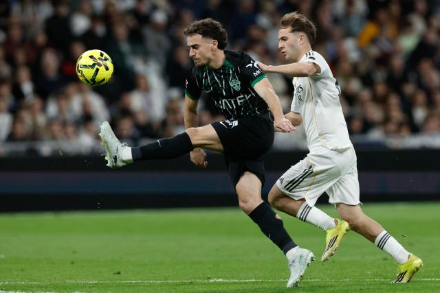 Elche's Spanish defender #03 Adria Pedrosa (L) controls the ball challenged by Real Madrid's Spanish forward #42 Daniel Yanez during the Spanish league football match between Real Madrid CF and Elche CF at the Santiago Bernabeu Stadium in Madrid on March 14, 2026. (Photo by Oscar DEL POZO / AFP)