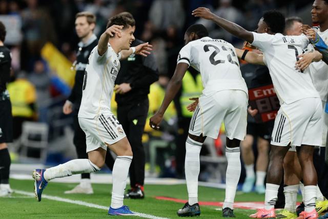 Real Madrid's Turkish midfielder #15 Arda Guler (L) celebrates scoring his team's fourth goal during the Spanish league football match between Real Madrid CF and Elche CF at the Santiago Bernabeu Stadium in Madrid on March 14, 2026. (Photo by Oscar DEL POZO / AFP)