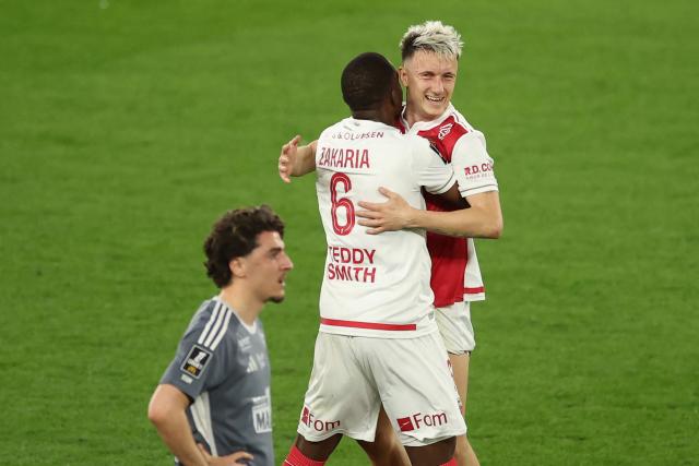 Monaco's Russian midfielder #10 Aleksandr Golovin (L) celebrates with Monaco's Swiss midfielder #06 Denis Zakaria after scoring his team's second goal during the French L1 football match between AS Monaco and Stade Brestois 29 at the Stade Louis II in the Principality of Monaco on March 14, 2026. (Photo by Valery HACHE / AFP)