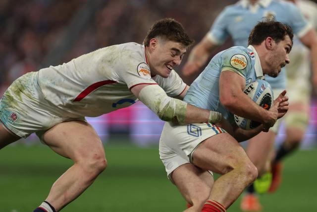 France's scrum-half Antoine Dupont (R) is tackled by England's wing Tommy Freeman (L) runs with the ball during of the Six Nations international rugby union match between France and England at the Stade de France, in Saint-Denis, north of Paris, on March 14, 2026. (Photo by FRANCK FIFE / AFP)