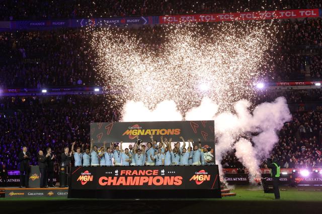 France's players celebrate with the trophy after winning the Six Nations international rugby union match between France and England at the Stade de France, in Saint-Denis, north of Paris, on March 14, 2026. (Photo by Thomas SAMSON / AFP)