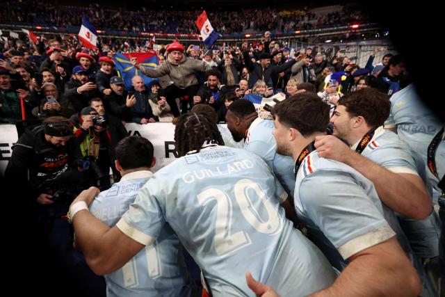 France's players celebrate winning the tournament with supporters following the Six Nations international rugby union match between France and England at the Stade de France, in Saint-Denis, north of Paris, on March 14, 2026. (Photo by FRANCK FIFE / AFP)