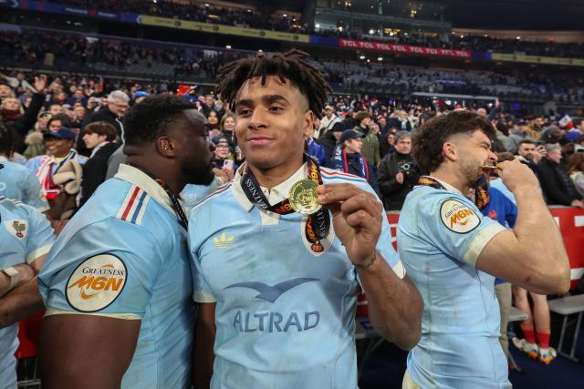 France's wing Théo Attissogbe  celebrates winning the tournament following the Six Nations international rugby union match between France and England at the Stade de France, in Saint-Denis, north of Paris, on March 14, 2026. (Photo by FRANCK FIFE / AFP)