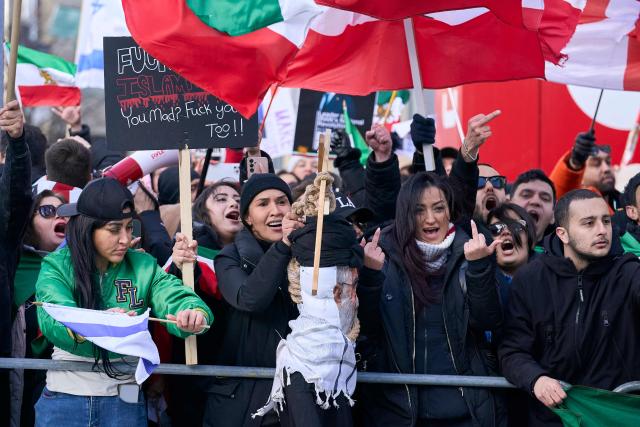 Pro-Israel counter protestors heckle Al-Quds day protestors as they march by in Toronto, Ontario, on March 14, 2026. (Photo by Geoff Robins / AFP)