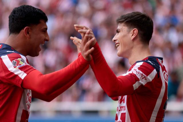 Guadalajara's forward #34 Armando Gonzalez (R) celebrates scoring his team's first goal during the Liga MX Clausura football match between Guadalajara and Santos Laguna at the Akron Stadium in Zapopan, Mexico on March 14, 2026. (Photo by Ulises RUIZ / AFP)