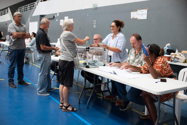 Voters queue to cast their ballots as they vote during the first round of France's 2026 municipal elections at the Anse Vata Sports Arena in Noumea, in the French overseas collectivity of New Caledonia, on March 15, 2026. Voters queue to casts their balltos as they vote 
Residents of Noumea are voting in the municipal elections at the Anse Vata Sports Arena in Noumea.New Caledonia, Noumea, March 15, 2026. Photography by Delphine Mayeur / AFP.Les Noumeens votent aux elections municipales a la salle Omnisports de lAnse Vata a Noumea.Nouvelle-Caledonie, Noumea, 15 mars 2026. Photographie par Delphine Mayeur / AFP. (Photo by Delphine MAYEUR / AFP)