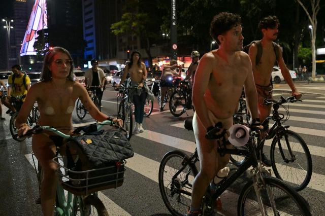 EDITORS NOTE: Graphic content / Naked cyclists demonstrate along Paulista Avenue to demand better conditions on the city’s roads and to raise awareness about cyclist safety and reducing oil dependence, as part of the World Naked Bike Ride international movement in Sao Paulo, Brazil, on March 14, 2026. (Photo by Nelson ALMEIDA / AFP)