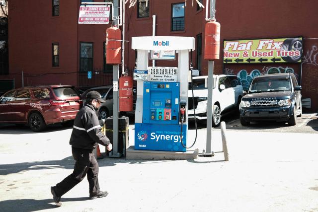 A man walks past a fuel pump at a gas station in the Manhattan borough of New York, on March 14, 2026. (Photo by CHARLY TRIBALLEAU / AFP)