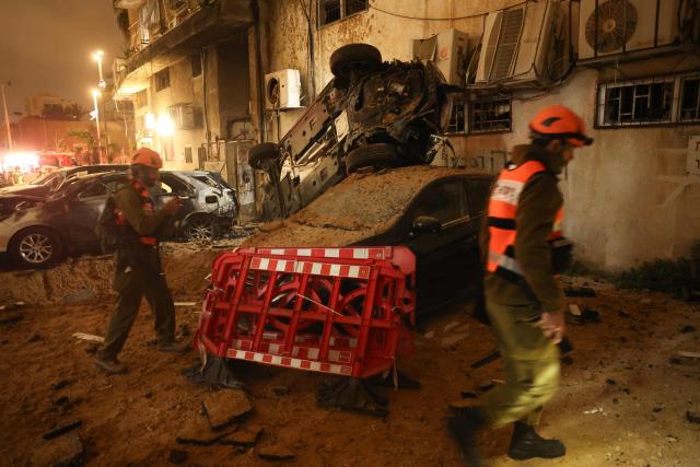 Israeli security checks the damage to cars after a rocket strike in Holon, Israel, on March 15, 2026. (Photo by Jack GUEZ / AFP) / Attention editors: Photo taken with approval from the Ministry of Culture and Islamic Guidance (Ershad) --
AFP covers the war in the Middle East through its extensive regional network, including bureaus in Tehran, Jerusalem, and several neighboring countries. Since the start of the conflict, journalists have been working under increasingly restrictive conditions. Authorities in several countries have limited reporters' movements, photo and live video coverage from sensitive locations. Some governments and armed groups have banned images of missile or drone strikes and other security-related sites. / 