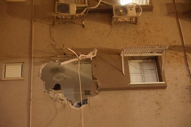 A building damaged by a rocket strike is seen in Holon, Israel, on March 15, 2026. (Photo by Jack GUEZ / AFP) / Attention editors: Photo taken with approval from the Ministry of Culture and Islamic Guidance (Ershad) --
AFP covers the war in the Middle East through its extensive regional network, including bureaus in Tehran, Jerusalem, and several neighboring countries. Since the start of the conflict, journalists have been working under increasingly restrictive conditions. Authorities in several countries have limited reporters' movements, photo and live video coverage from sensitive locations. Some governments and armed groups have banned images of missile or drone strikes and other security-related sites. / 