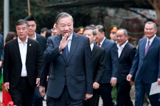 Vietnam's Communist Party Secretary General To Lam waves after casting his ballot at a voting station in Hanoi on March 15, 2026. Polls opened in Vietnam with voters casting ballots for members of the National Assembly, the country's top legislative body that serves mainly to ratify decisions by the ruling Communist Party. (Photo by -STR / AFP)