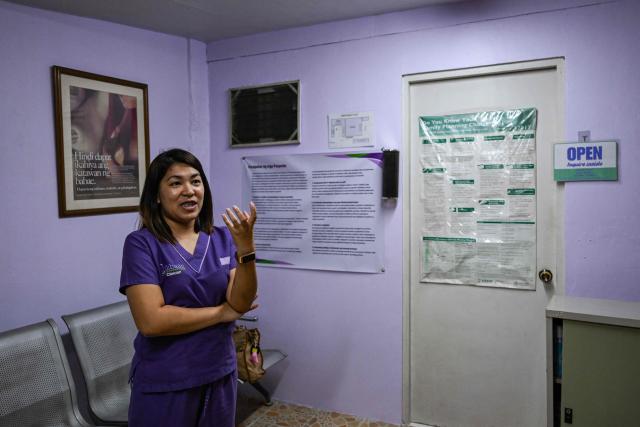This photo taken on December 3, 2025, shows a health worker showing the facility inside the Likhaan Center for Women’s Health in Quezon City, Metro Manila. Abortions are strictly outlawed in the mainly Catholic Philippines, forcing women to turn to a patchwork of providers operating in the online shadows. (Photo by Jam STA ROSA / AFP) / TO GO WITH STORY: Philippines-abortion-health-religion, FOCUS by Ara Eugenio and Pam Castro