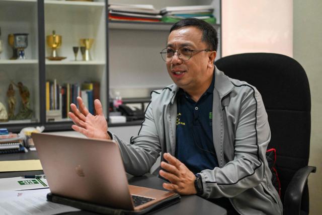 This photo taken on February 10, 2026, shows Dan Cancino, Executive Secretary of Catholic Bishops' Conference of the Philippines (CBCP) - Episcopal Commission on Health Care, talking during an interview with AFP in Quezon City, Metro Manila. Abortions are strictly outlawed in the mainly Catholic Philippines, forcing women to turn to a patchwork of providers operating in the online shadows. (Photo by Jam STA ROSA / AFP) / TO GO WITH STORY: Philippines-abortion-health-religion, FOCUS by Ara Eugenio and Pam Castro
