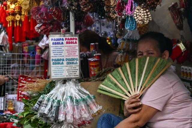 This photo taken on February 13, 2026, shows a stall signage that says “pamparegla” which refers to medication believed to help stimulate menstruation along a street in Manila. Abortions are strictly outlawed in the mainly Catholic Philippines, forcing women to turn to a patchwork of providers operating in the online shadows. (Photo by Jam STA ROSA / AFP) / TO GO WITH STORY: Philippines-abortion-health-religion, FOCUS by Ara Eugenio and Pam Castro