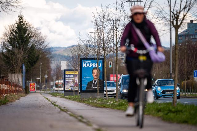 Cars pass by electoral billboards ahead of Slovenia's general elections in Ljubljana on March 13, 2026. (Photo by Jure Makovec / AFP)