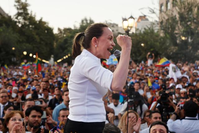 (FILES) Venezuelan opposition leader Maria Corina Machado gestures as she speaks to members of the Venezuelan community during an encounter in Chile at Almagro Square in Santiago on March 12, 2026. Venezuelan opposition leader and Nobel Peace Prize laureate Marнa Corina Machado said on March 14, 2025, that “selective justice” is being applied in Venezuela after her lawyer—who was arrested following Nicolбs Maduro’s controversial reelection—was denied amnesty. (Photo by Raul BRAVO / AFP)