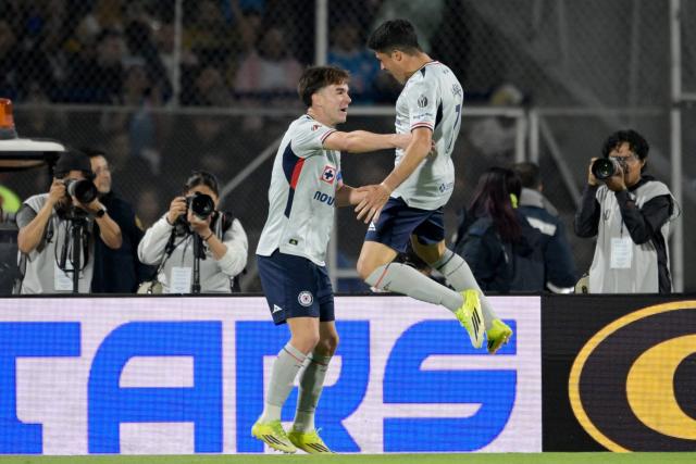 Cruz Azul's forward #07 Nicolas Ibanez (R) celebrates with teammate Argentine midfielder #08 Agustin Palavecino after scoring the opening goal during the Liga MX Clausura match between Pumas and Cruz Azul at the Olimpico Universitario Stadium in Mexico City on March 14, 2026. (Photo by Alfredo ESTRELLA / AFP)