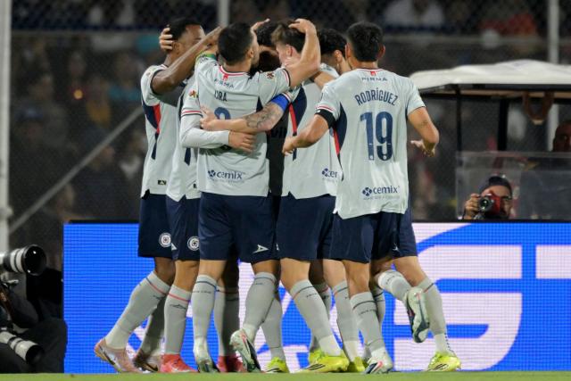 Cruz Azul's forward #07 Nicolas Ibanez (unseen) celebrates with teammates scoring the opening goal during the Liga MX Clausura match between Pumas and Cruz Azul at the Olimpico Universitario Stadium in Mexico City on March 14, 2026. (Photo by Alfredo ESTRELLA / AFP)