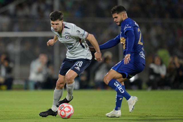 Cruz Azul's Argentine forward #20 Jose Paradela and Pumas' forward #22 Alan Medina fight for the ball during the Liga MX Clausura match between Pumas and Cruz Azul at the Olimpico Universitario Stadium in Mexico City on March 14, 2026. (Photo by Alfredo ESTRELLA / AFP)