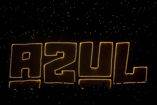 TOPSHOT - Fans of Cruz Azul cheer for their team ahead of the Liga MX Clausura match between Pumas and Cruz Azul at the Olimpico Universitario Stadium in Mexico City on March 14, 2026. (Photo by Alfredo ESTRELLA / AFP)