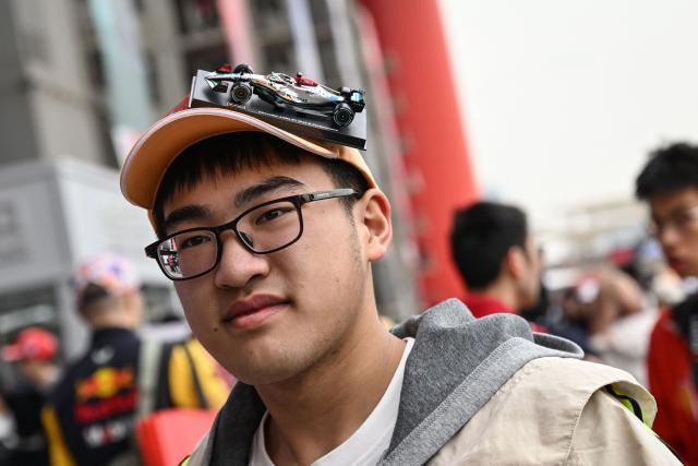 A supporter of Mercedes arrives for the Formula One Chinese Grand Prix at the Shanghai International Circuit in Shanghai on March 15, 2026. (Photo by Jade GAO / AFP)