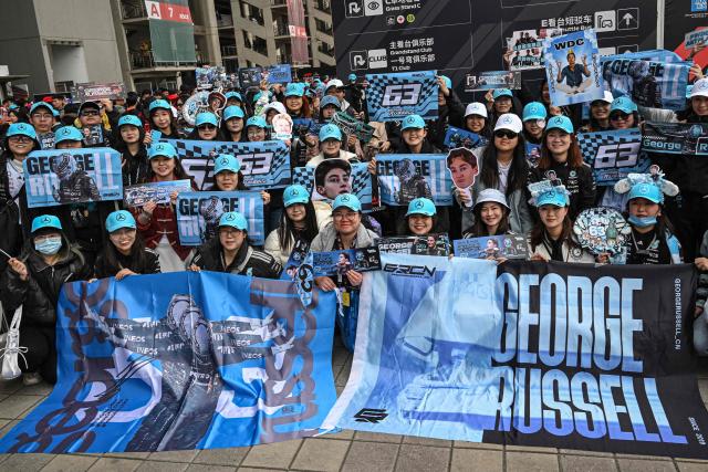 Supporters of Mercedes' British driver George Russell pose as they arrive for the Formula One Chinese Grand Prix at the Shanghai International Circuit in Shanghai on March 15, 2026. (Photo by Jade GAO / AFP)