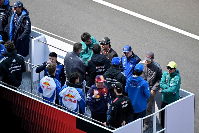 Pilots take part in the drivers' parade prior to the Formula One Chinese Grand Prix at the Shanghai International Circuit in Shanghai on March 15, 2026. (Photo by HECTOR RETAMAL / AFP)