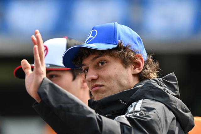 Mercedes' Italian driver Kimi Antonelli gestures during the drivers' parade prior to the Formula One Chinese Grand Prix at the Shanghai International Circuit in Shanghai on March 15, 2026. (Photo by Greg Baker / AFP)