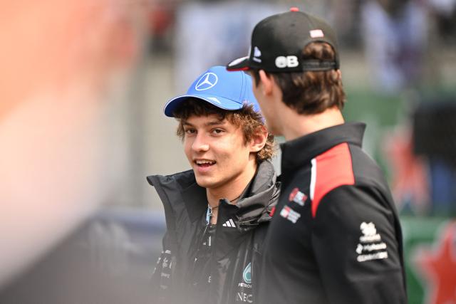 Mercedes' Italian driver Kimi Antonelli (C) speaks during the drivers' parade prior to the Formula One Chinese Grand Prix at the Shanghai International Circuit in Shanghai on March 15, 2026. (Photo by Greg Baker / AFP)