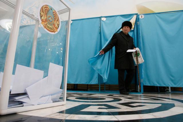 A man leaves a voting booth to cast his ballot at a polling station during the constitutional referendum in Almaty on March 15, 2026. (Photo by Ruslan PRYANIKOV / AFP)