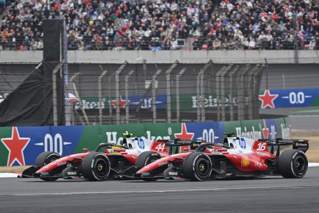 Ferrari's British driver Lewis Hamilton (L) and Ferrari's Monegasque driver Charles Leclerc (R) drive during the Formula One Chinese Grand Prix at the Shanghai International Circuit in Shanghai on March 15, 2026. (Photo by HECTOR RETAMAL / AFP)