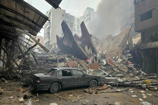 Debris from a collapsed building blocks the road at the site of an Israeli airstrike in Beirut’s southern suburb Haret Hreik on March 15, 2026. Lebanon is working to form a delegation to negotiate with Israel in a bid to stop the war with Iran-backed Hezbollah, an official told AFP, though Israel has not committed to the initiative. (Photo by AFP) / 