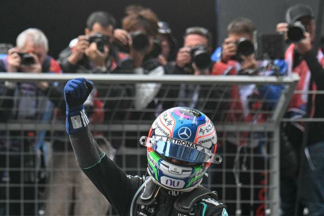 Mercedes' Italian driver Kimi Antonelli celebrates his victory after the Formula One Chinese Grand Prix at the Shanghai International Circuit in Shanghai on March 15, 2026. (Photo by HECTOR RETAMAL / AFP)