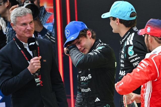 First-placed Mercedes' Italian driver Kimi Antonelli (2L) celebrates winning alongside Mercedes' British driver George Russell (2R) and Ferrari's British driver Lewis Hamilton (R) after the Formula One Chinese Grand Prix at the Shanghai International Circuit in Shanghai on March 15, 2026. (Photo by JADE GAO / AFP)