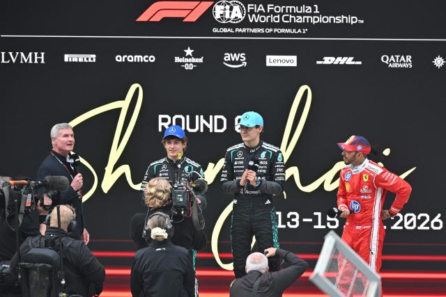 Winner Mercedes' Italian driver Kimi Antonelli (2nd L), second-placed Mercedes' British driver George Russell (C) and third-placed Ferrari's British driver Lewis Hamilton (R) answer questions after the Formula One Chinese Grand Prix at the Shanghai International Circuit in Shanghai on March 15, 2026. (Photo by HECTOR RETAMAL / AFP)