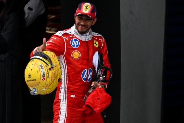 Third-placed Ferrari's British driver Lewis Hamilton celebrates after the Formula One Chinese Grand Prix at the Shanghai International Circuit in Shanghai on March 15, 2026. (Photo by JADE GAO / AFP)