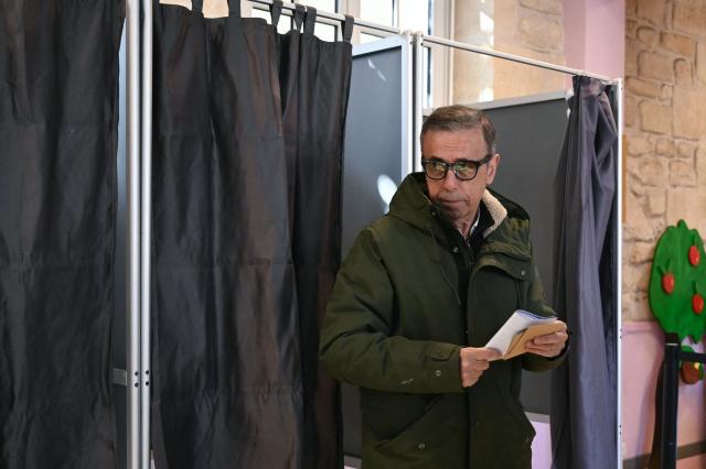 Bordeaux' Les Ecologistes mayor and candidate for his re-election Pierre Hurmic reacts as he leaves the polling booth to cast his ballot during the first round of France's 2026 municipal elections in Bordeaux, southwestern France, on March 15, 2026. (Photo by Philippe Lopez / AFP)