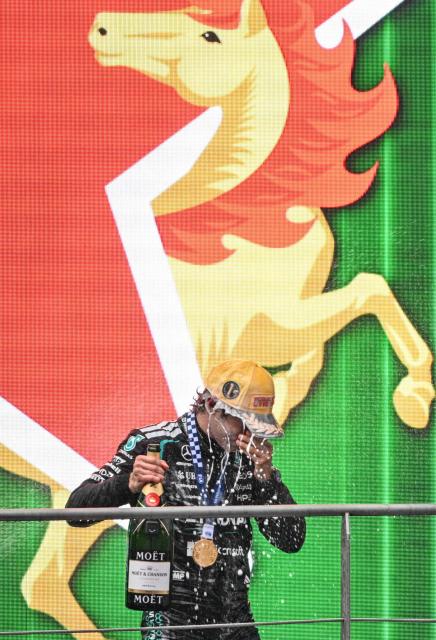 Mercedes' Italian driver Kimi Antonelli celebrates on the podium after winning the Formula One Chinese Grand Prix at the Shanghai International Circuit in Shanghai on March 15, 2026. (Photo by Hector RETAMAL / AFP)