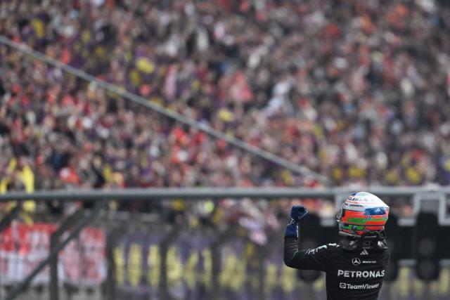 Mercedes' Italian driver Kimi Antonelli celebrates his victory after the Formula One Chinese Grand Prix at the Shanghai International Circuit in Shanghai on March 15, 2026. (Photo by JADE GAO / AFP)