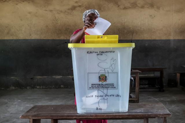 A voter casts her ballot at a polling station in Brazzaville on March 15, 2026 during the Republic of Congo's presidential elections. (Photo by Daniel BELOUMOU OLOMO / AFP)