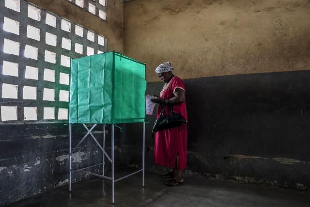 TOPSHOT - A voter enters a voting booth at a polling station in Brazzaville on March 15, 2026 during the Republic of Congo's presidential elections. (Photo by Daniel BELOUMOU OLOMO / AFP)
