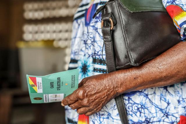 A voter holds her voting card at a polling station in Brazzaville on March 15, 2026 during the Republic of Congo's presidential elections. (Photo by Daniel BELOUMOU OLOMO / AFP)