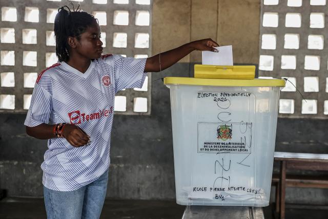 A voter casts her ballot at a polling station in Brazzaville on March 15, 2026 during the Republic of Congo's presidential elections. (Photo by Daniel BELOUMOU OLOMO / AFP)