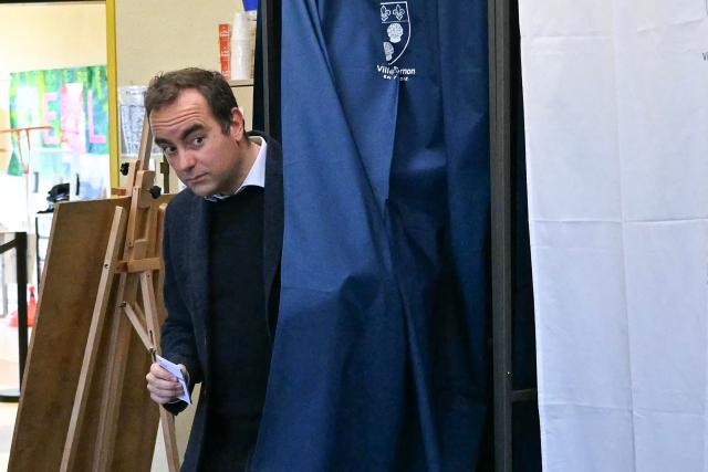France's Prime Minister Sebastien Lecornu, a candidate on the broad right-wing list "Generations Vernon", leaves a voting booth before casting his ballot during the first round of France's 2026 municipal elections in Vernon, northwestern France, on March 15, 2026. (Photo by Martin LELIEVRE / POOL / AFP)