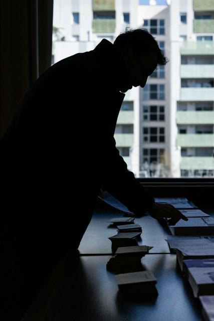 Incumbent mayor of Lyon and Europe-Ecology The Greens (EELV) party candidate for re-election Gregory Doucet collects the ballot papers prior to cast his ballot during the first round of France's 2026 municipal elections in Lyon, central eastern France, on March 15, 2026. (Photo by ARNAUD FINISTRE / AFP)