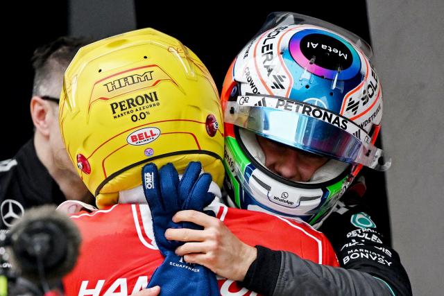 Winner Mercedes' Italian driver Kimi Antonelli (R) is congratulated by third-placed Ferrari's British driver Lewis Hamilton after the Formula One Chinese Grand Prix at the Shanghai International Circuit in Shanghai on March 15, 2026. (Photo by GREG BAKER / AFP)