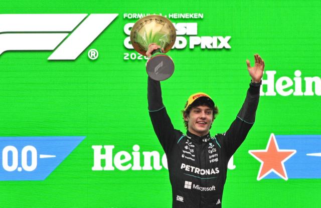 Mercedes' Italian driver Kimi Antonelli celebrates on the podium after winning the Formula One Chinese Grand Prix at the Shanghai International Circuit in Shanghai on March 15, 2026. (Photo by Hector RETAMAL / AFP)